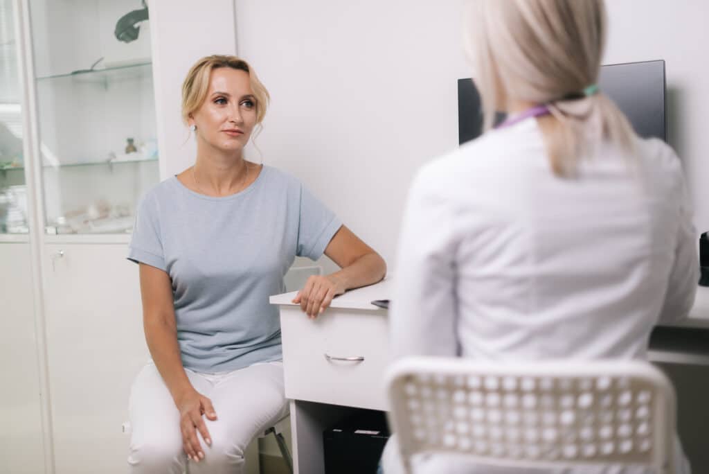 Bigstock young blonde woman at doctor c 320651332